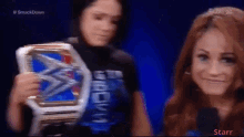 a woman holding a smackdown championship belt