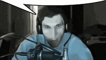 a man wearing headphones talking into a microphone with a speech bubble above him