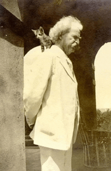 a man with a kitten on his back