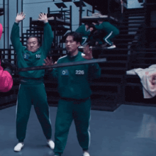 a man in a green tracksuit with the number 226 on it