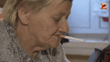 a woman smoking a cigarette with a tv logo in the corner