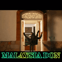 a man is upside down in a doorway with the words malaysia don written below him