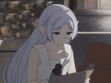 a girl with white hair and elf ears is reading a scroll