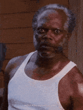a man with a beard wearing a white tank top says " how you want yo ribs "