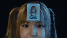 a girl has a card on her forehead that says next chapter