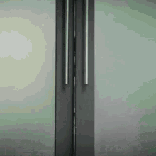a close up of a stainless steel refrigerator door with two handles