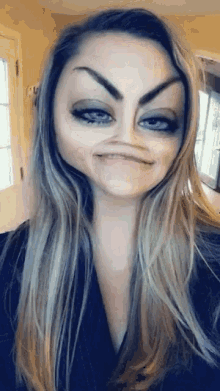a woman with long hair is making a funny face with her eyes closed