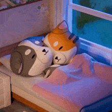 two stuffed animals are laying on a bed next to a window