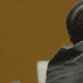 a man in a suit and tie is hugging another man in a suit .