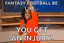 a woman in a red dress is holding a microphone and saying `` fantasy football be like you get an injury ! ''