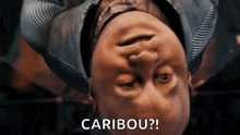 a close up of a person 's face with the words caribou behind it