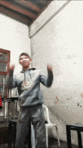 a boy wearing a sweatshirt that says ' a ' on it is dancing in a room