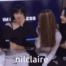 a group of girls are sitting next to each other and one of them says nilclaire