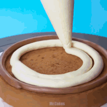 a chocolate cake is being frosted with white frosting and the word mr.cakes is on the bottom
