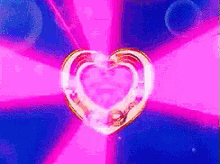 a pink and blue background with a heart shaped object in the middle