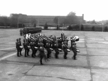 a black and white photo of a military band marching