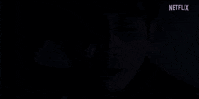 a man is laying in bed with his eyes closed and a netflix logo in the corner .