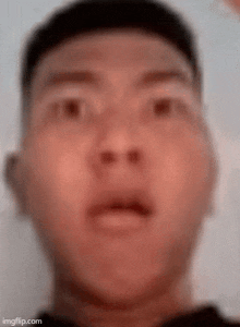 a close up of a man 's face with his mouth open .