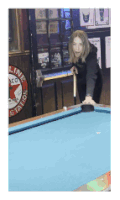 a woman holds a pool cue on a pool table in front of a sign that says ' line station '