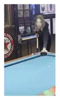 a woman holds a pool cue on a pool table in front of a sign that says ' line station '