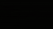 a gray and black background with a few white dots on it