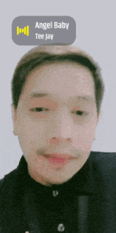 a close up of a man 's face with an angel baby tee jay sticker