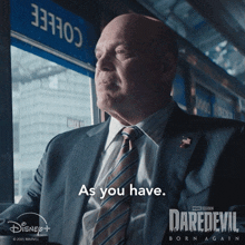 a man in a suit and tie with the words as you have