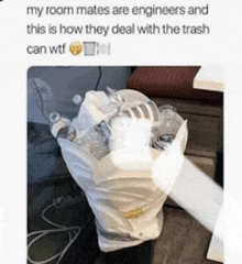 a person is holding a trash bag full of bottles and cans ..