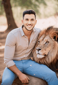 a man is sitting next to a lion and smiling at the camera