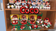 a bunch of stuffed ladybugs on a shelf with the word coco on top
