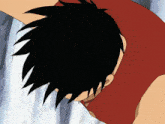 a person with black hair and a red shirt is laying down