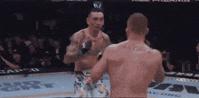 two men are fighting in a boxing ring with a sign that says rapid on it