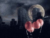 a bunch of pink balloons are floating in the air in front of a city skyline
