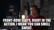 a man in a red shirt is talking about front-row seats right in the action . i mean , you can smell sweat