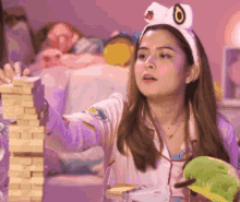 a girl wearing a headband with a strawberry on it