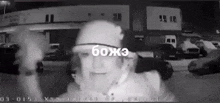 a black and white photo of a man wearing a baseball cap with the word boja on it