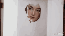 a person is painting a woman 's face with a brush and made in animatica