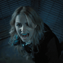 a woman screaming with her mouth wide open
