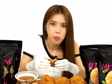 a woman is eating chicken nuggets in front of a bag that says melting