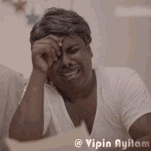 a man with a mustache is covering his face with his hand and the caption vipin ayilam