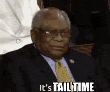 a man in a suit and tie says " it 's tail time "