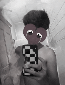 a man is taking a selfie with a heart shaped mask on his face