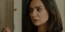 a close up of a woman 's face with her eyes closed