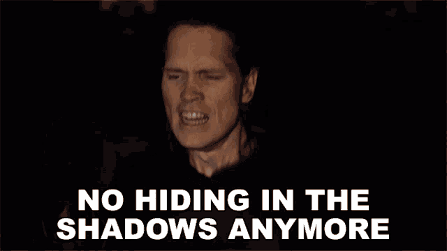 a man singing a song with the words no hiding in the shadows anymore