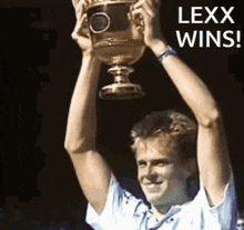 a man is holding a trophy in his hands with the words lexx wins below him .