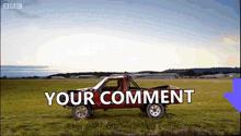 a red truck is parked in a grassy field with the words " your comment " on the bottom