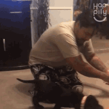 Playing With The Dog Happily GIF - Playing With The Dog Happily Pulling The Dogs Toy GIFs