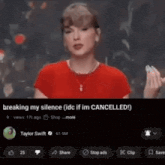 a woman in a red shirt is holding a cell phone in her hand .