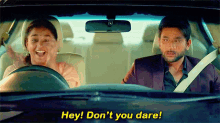 a man and a woman are in a car and the man is saying " hey don 't you dare "