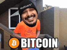 a man wearing an orange shirt and a black hat with the word bitcoin on it